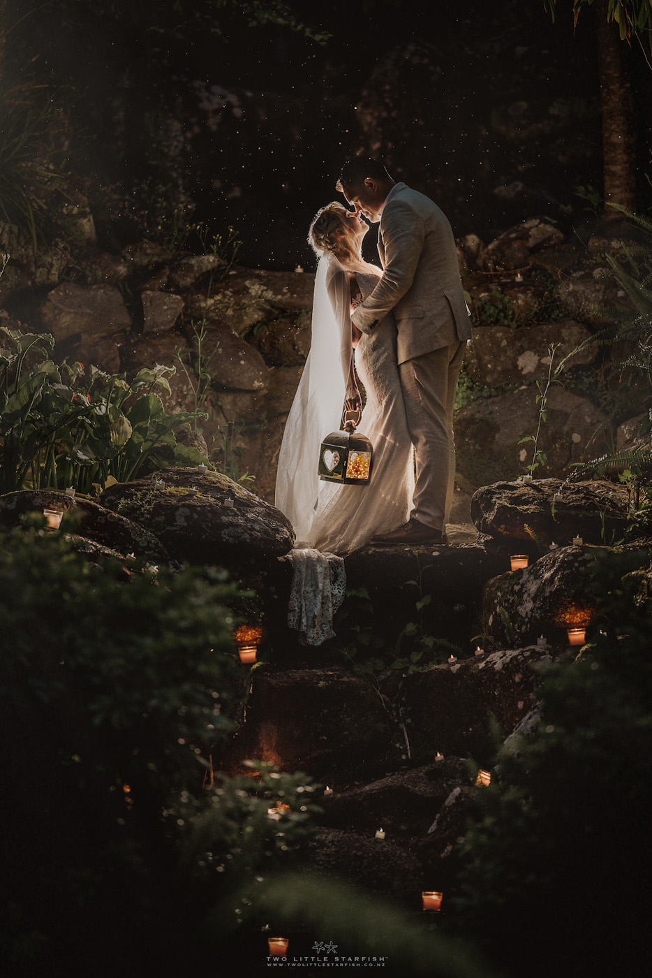Night wedding portrait with lantern and candlelight